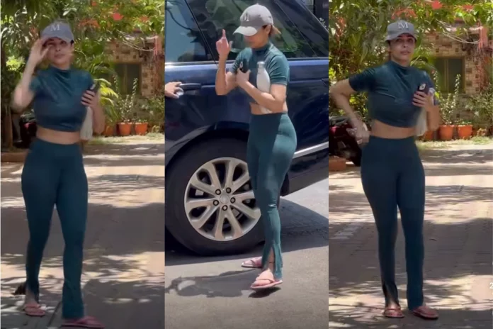 malaikaarora The stunning star was captured by photographers as she stepped out of her car turquoise cropped top paired with jeggings and a cap