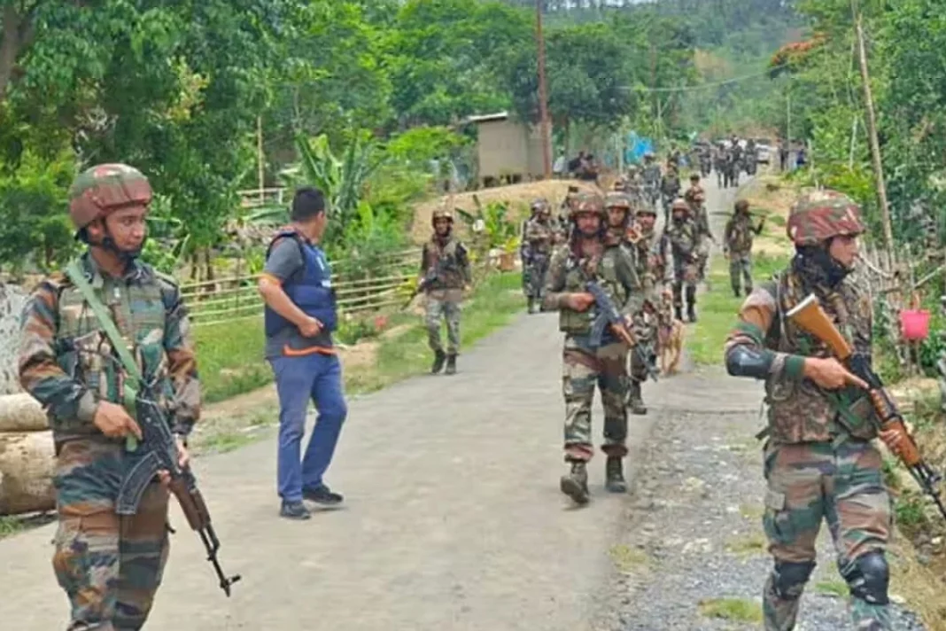 Women led mob forces army to hand over 12 militants in a standoff.