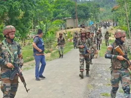 Women led mob forces army to hand over 12 militants in a standoff.