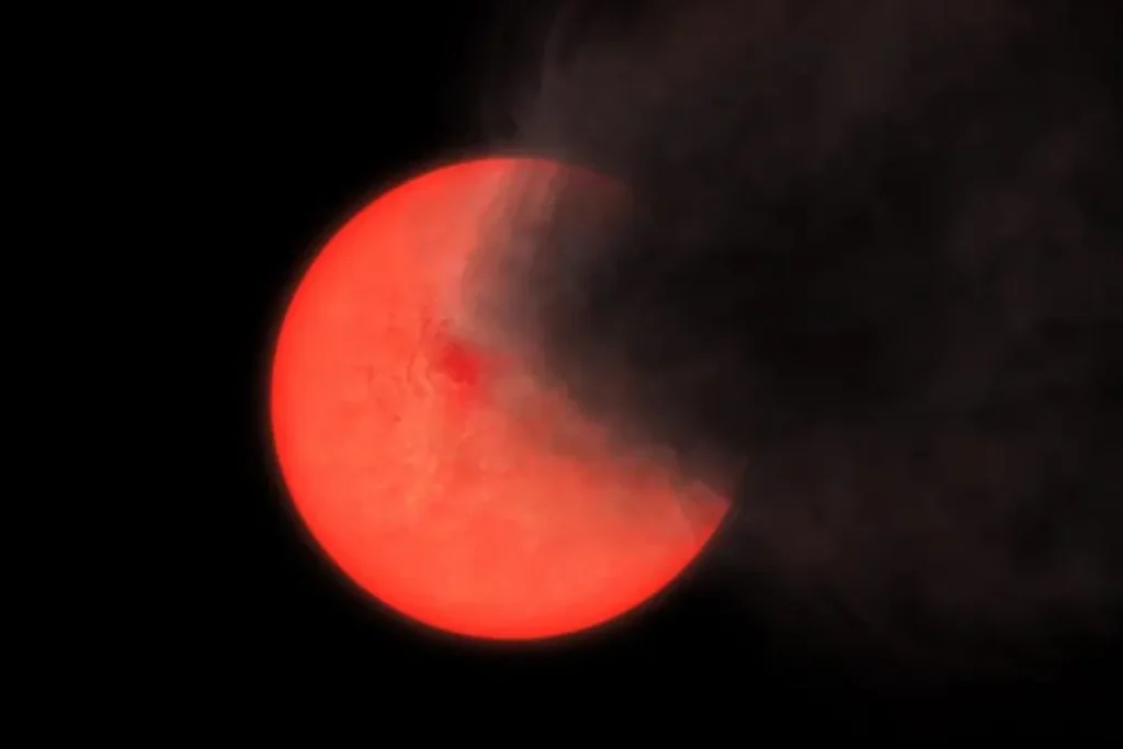 An artist's rendition depicting a cloud of smoke and dust ejected by a red giant star. Credit: Philip Lucas/ University of Hertfordshire